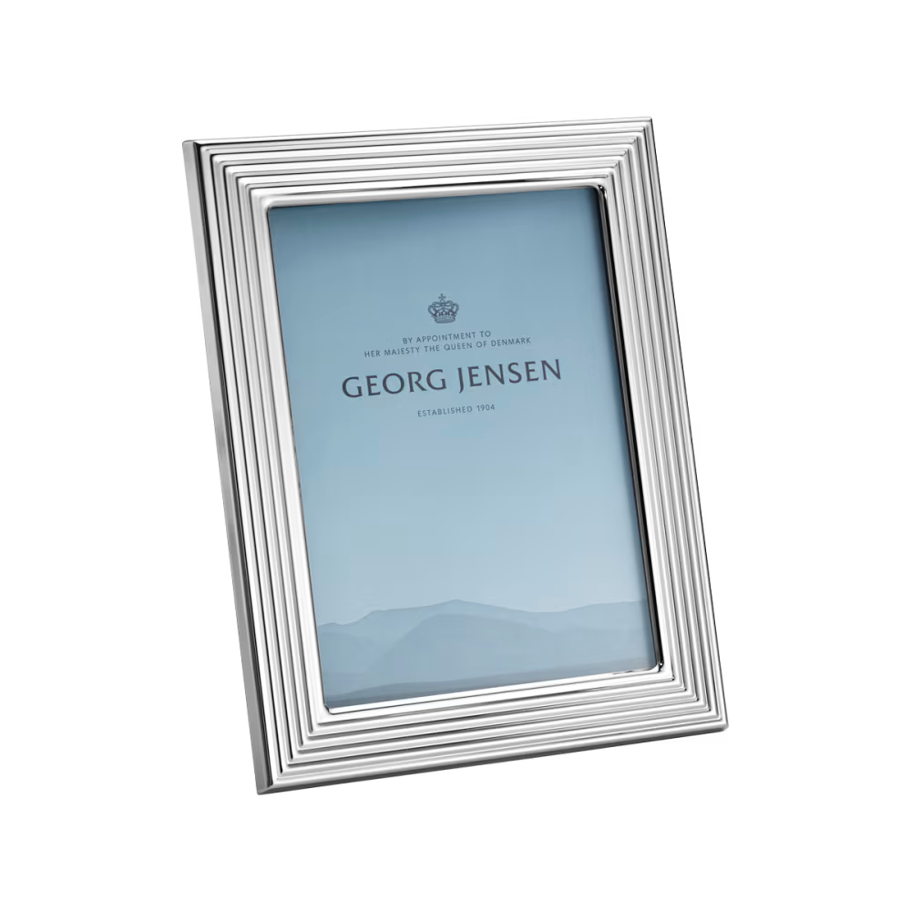 Close-up of the Georg Jensen Bernadotte medium picture frame showcasing polished stainless steel and grooved detailing.