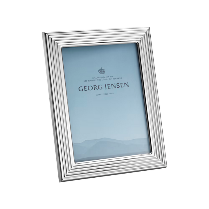 Close-up of the Georg Jensen Bernadotte medium picture frame showcasing polished stainless steel and grooved detailing.