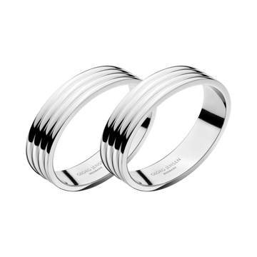 Close-up of the Georg Jensen Bernadotte Napkin Rings showcasing polished stainless steel and grooved design.