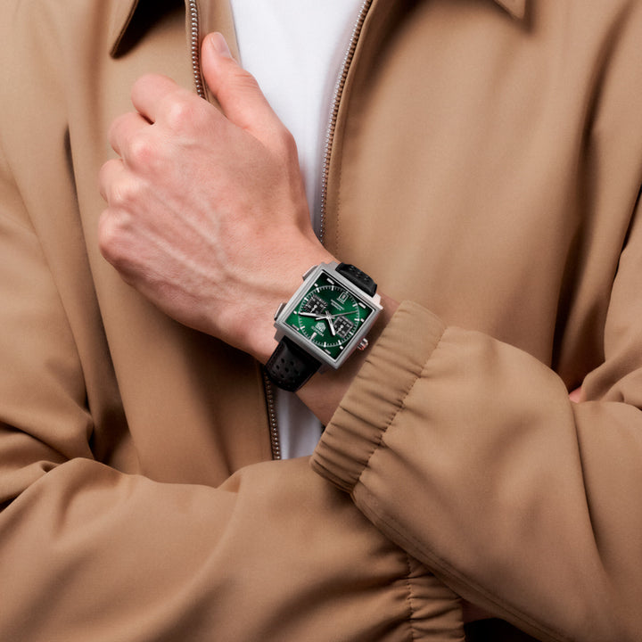 TAG Heuer Monaco CDW2180.FC8360 green dial watch lifestyle shot. worn by male in beige bomber jacket.