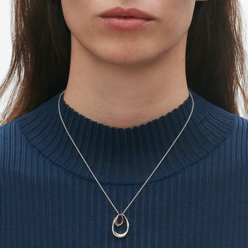 Luxury Georg Jensen Offspring pendant necklace featuring organic silver and rose gold forms.