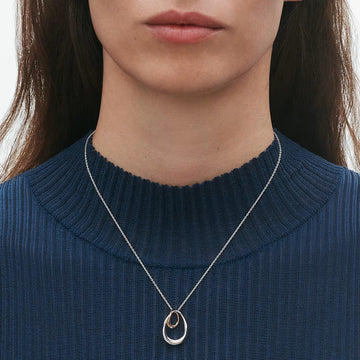 Luxury Georg Jensen Offspring pendant necklace featuring organic silver and rose gold forms.