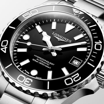 Close-up of Longines HydroConquest watch featuring black face, luminous hands, rotating bezel and stainless steel strap
