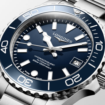 Close-up of Longines HydroConquest watch with blue face, luminous hands, rotating bezel and stainless steel strap