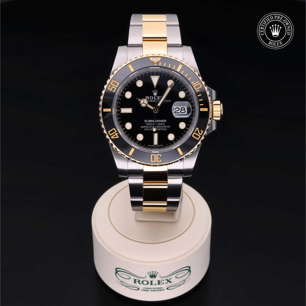 Angled view of the Rolex Certified Pre-Owned Submariner Date M16613 in Oystersteel and yellow gold with black dial and rotating black bezel.
