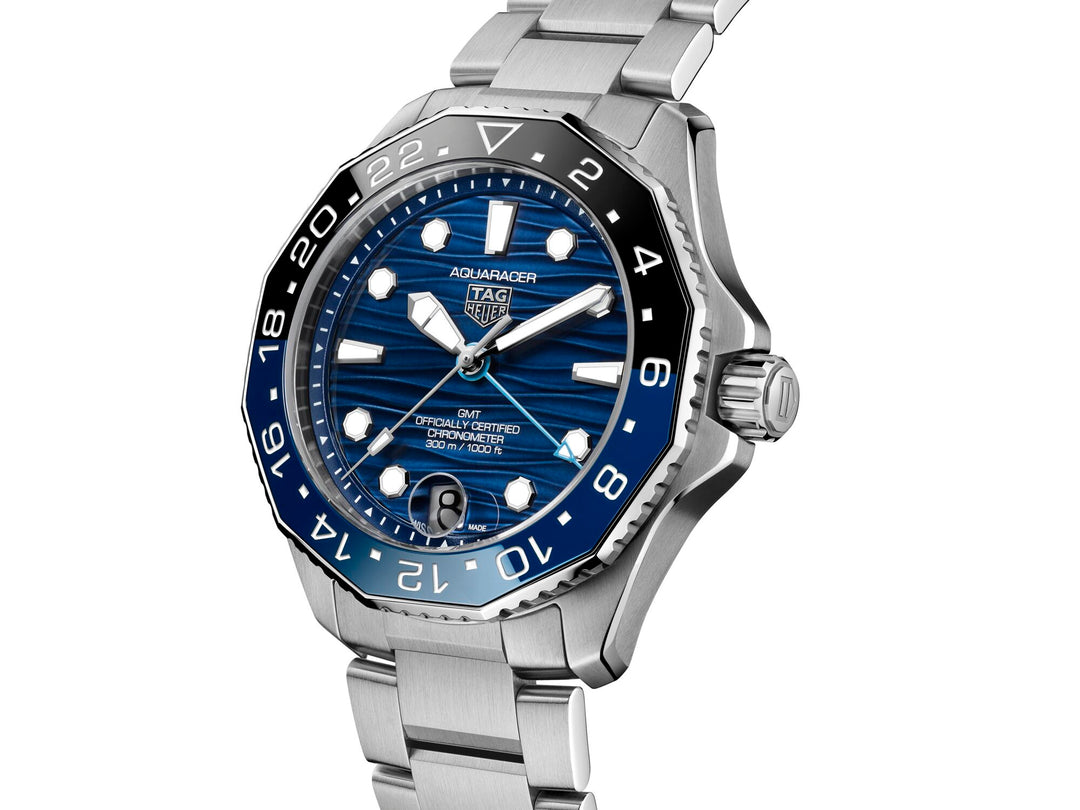 TAG Heuer Aquaracer Professional 300 GMT watch face with blue sunray dial, luminous markers, date window, and GMT hand