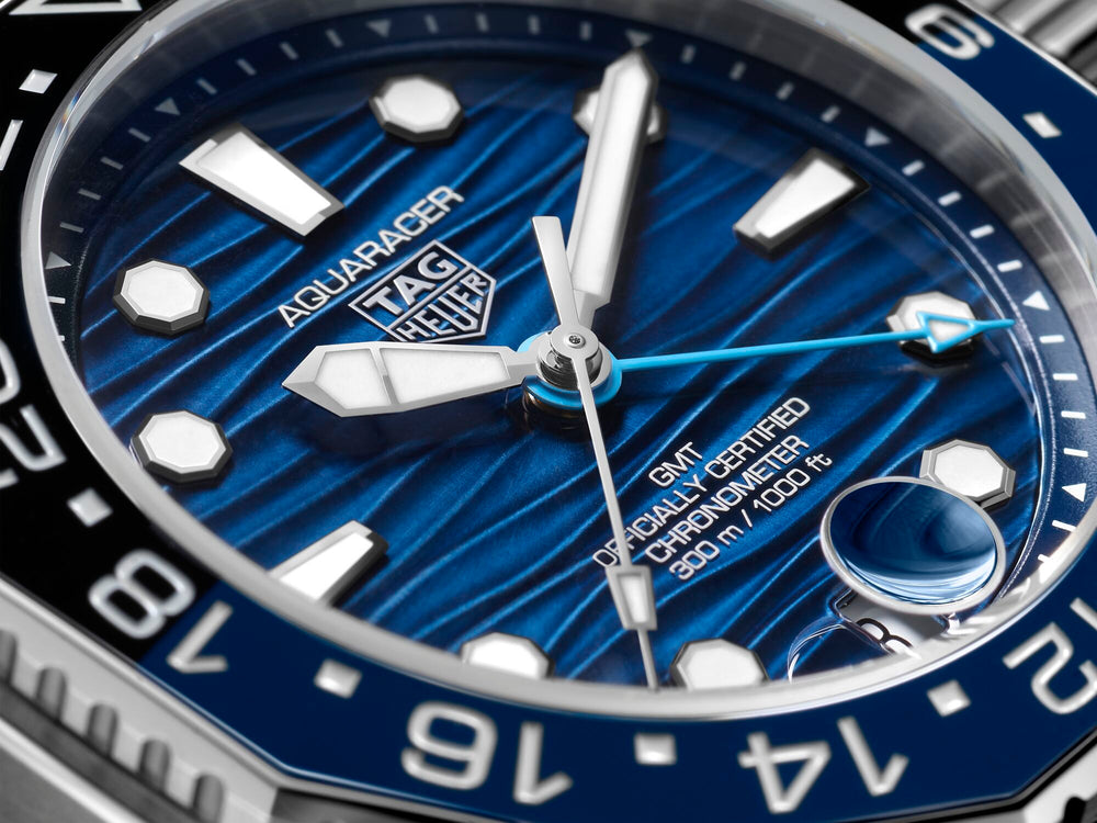 Close-up of TAG Heuer Aquaracer Professional 300 GMT ceramic bezel and crown with precision-finished stainless steel case