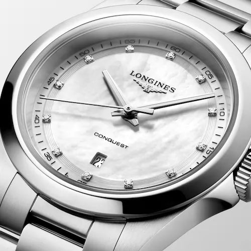 Longines Conquest 30mm ladies watch featuring a white mother-of-pearl dial and steel bracelet